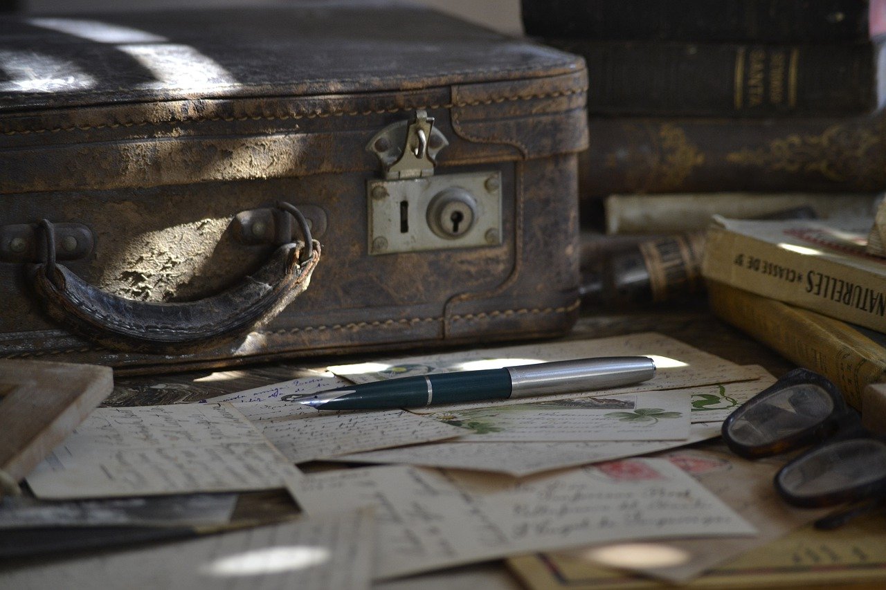 suitcase with paper and pen